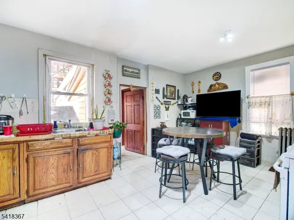 a living room with furniture a flat screen tv and a window