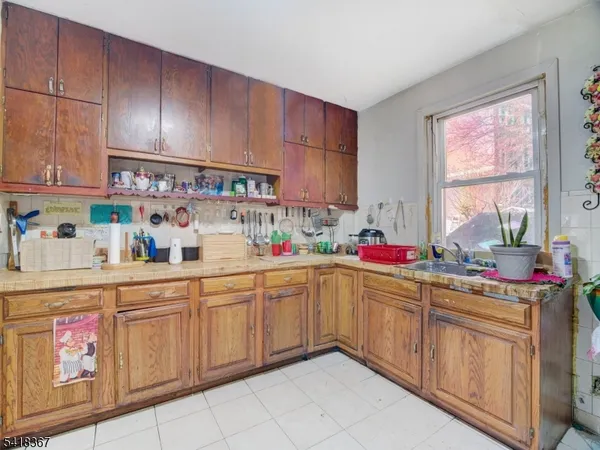 a kitchen with a sink window and cabinets