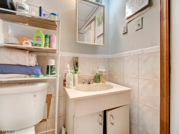 a room with stainless steel appliances a sink and a refrigerator