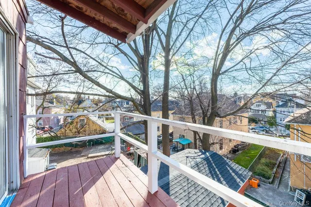 a view of balcony with furniture and wooden fence