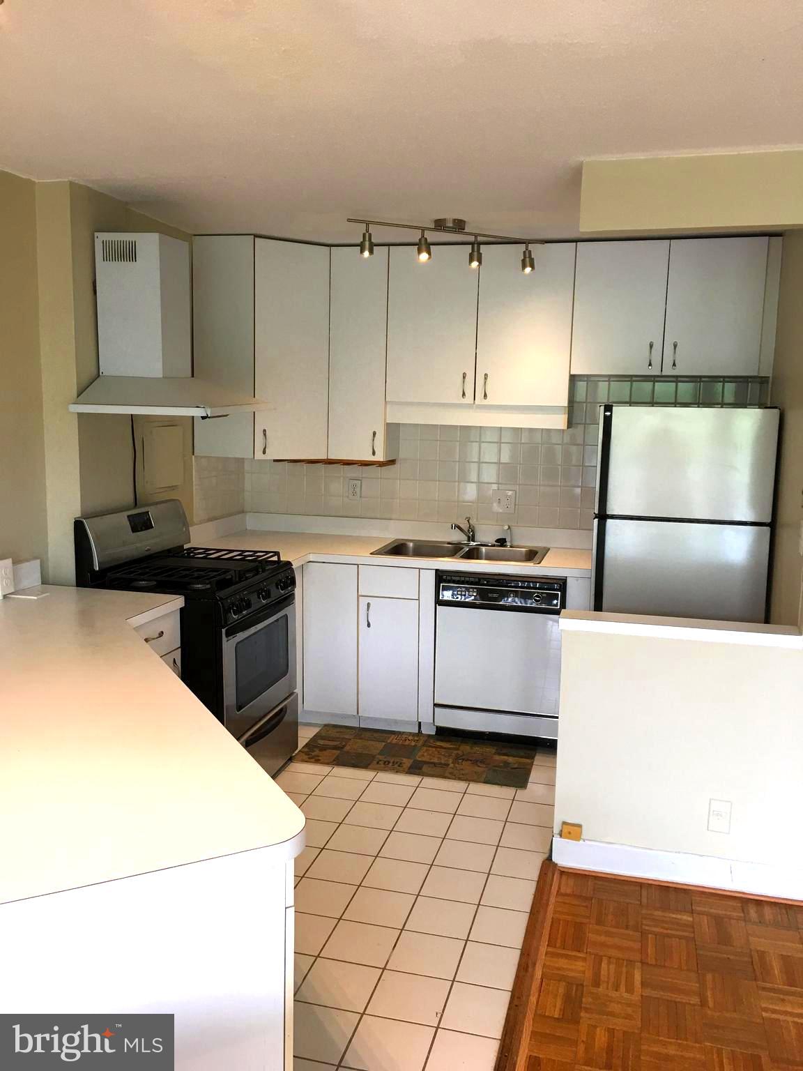 1301 South Arlington Ridge Road, Unit 203 Arlington, VA 22202 - Photo 14 of 31 Kitchen has tile floor and stainless appliances