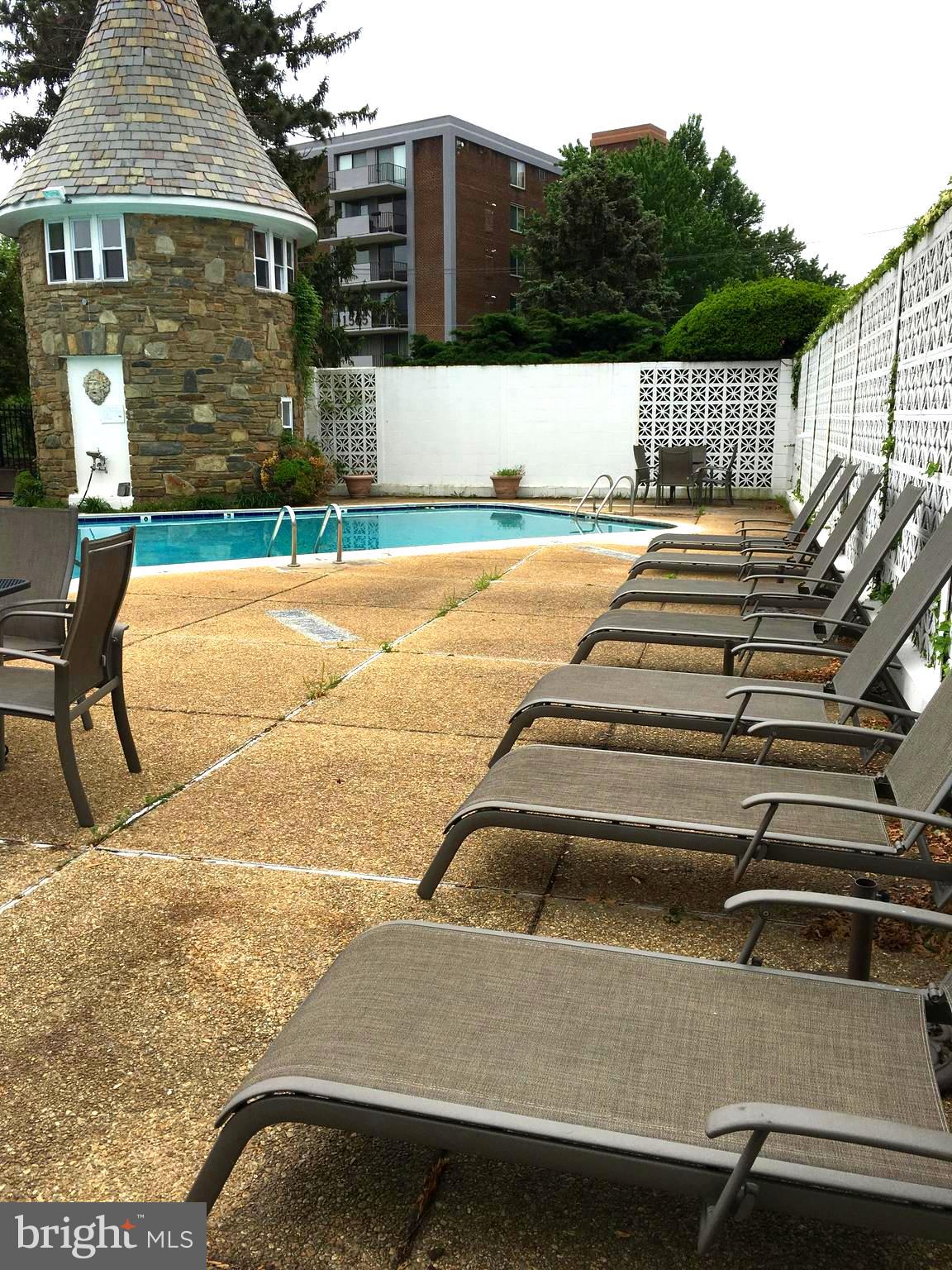 1301 South Arlington Ridge Road, Unit 203 Arlington, VA 22202 - Photo 30 of 31 Pool area with deck chairs for sunny day tanning