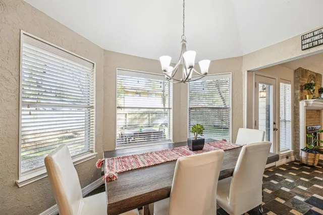 a view of a dining room with furniture wooden floor and chandelier