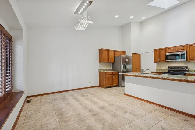 a view of an empty room with a fireplace and a window
