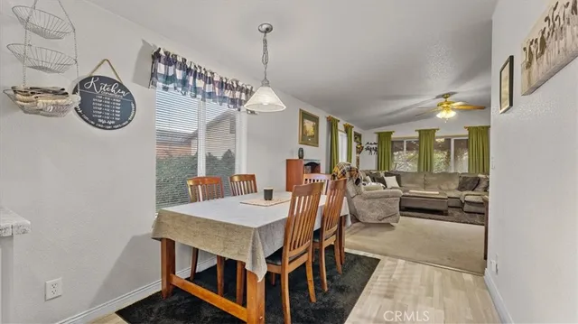 a view of a dining room with furniture and a book shelf