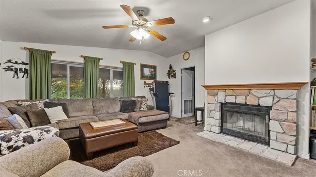 a living room with furniture ceiling fan and a rug