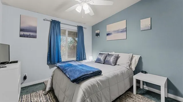 a view of a backyard with a table and chairs under an umbrella