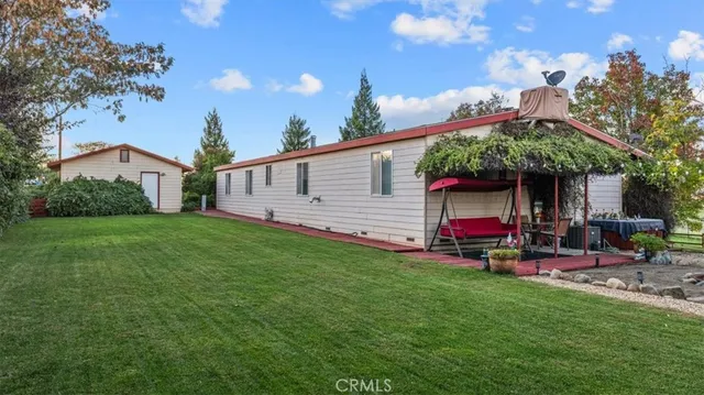a view of a garden with a house in the background
