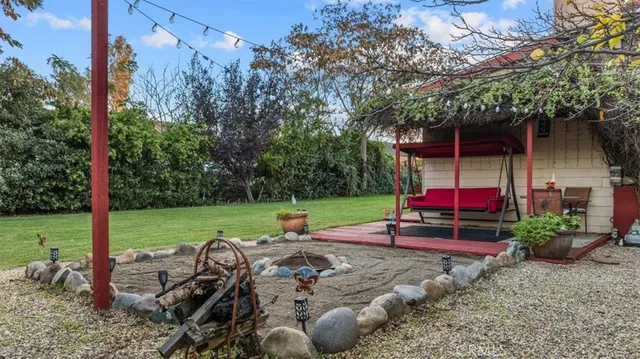 a view of a house with backyard and sitting area