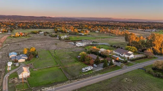 an aerial view of a pool and a yard