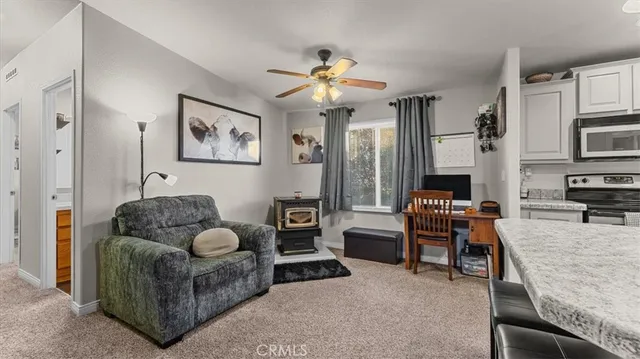 a kitchen with stainless steel appliances granite countertop a sink a stove and refrigerator