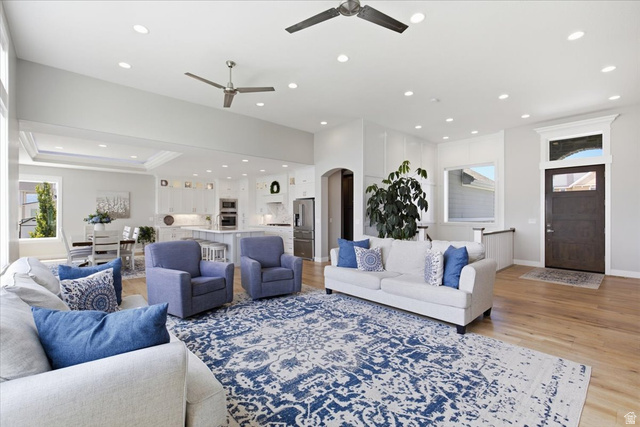 21 Pier Place Tooele, UT 84074 - Photo 12 of 112 Spacious living area featuring light wood-finish flooring, recessed lighting, and two ceiling fans