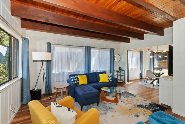 a kitchen with stainless steel appliances granite countertop counter space and chairs in it