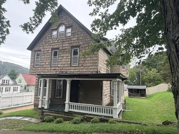 a front view of a house with a yard