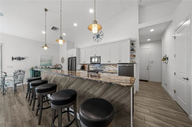 a kitchen with kitchen island a stove and a wooden floors