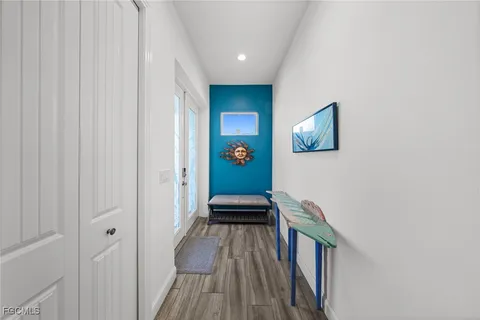 a view of a hallway with wooden floor and staircase