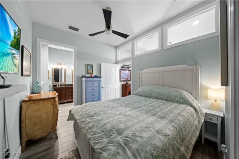 a bedroom with a large bed and a chandelier
