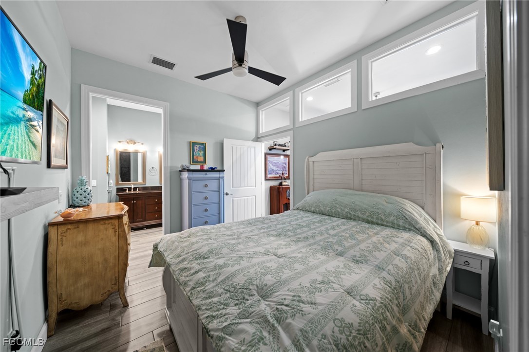 2743 Janet Street Matlacha, FL 33993 - Photo 15 of 45 a bedroom with a large bed and a chandelier