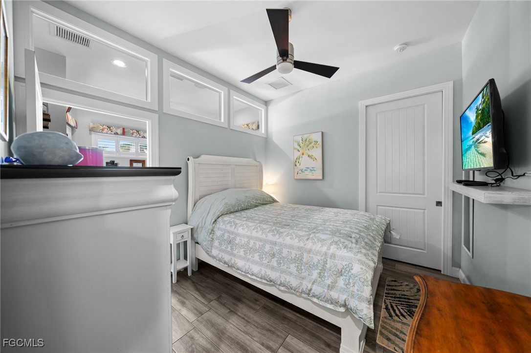 2743 Janet Street Matlacha, FL 33993 - Photo 16 of 45 a bedroom with a bed and a flat tv screen on dresser