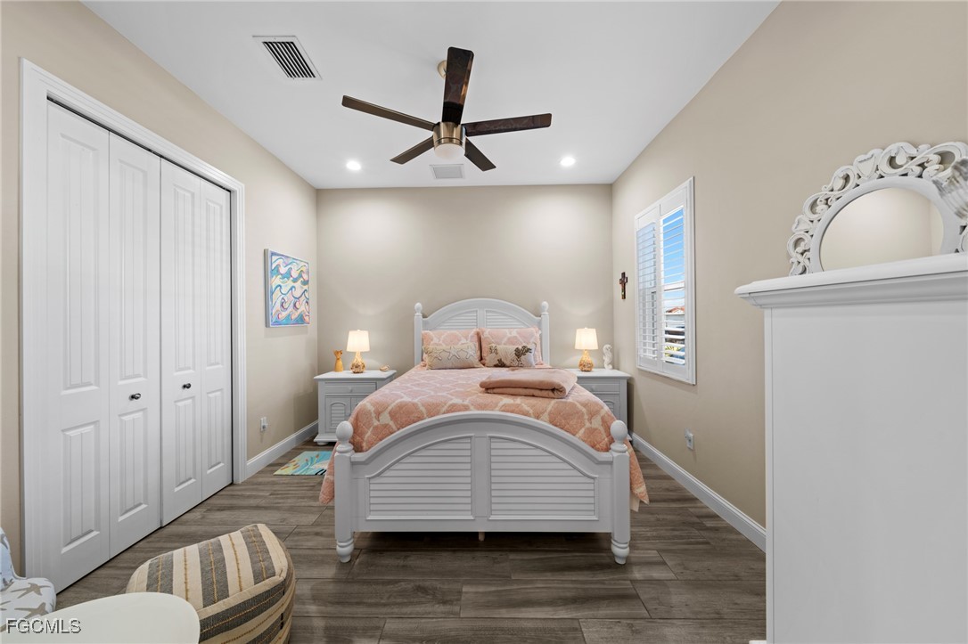 2743 Janet Street Matlacha, FL 33993 - Photo 20 of 45 a bedroom with a bed and wooden floor