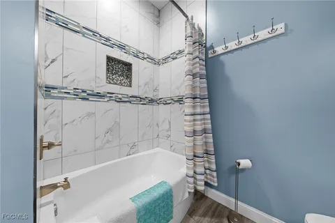 a bathroom with a bathtub and shower