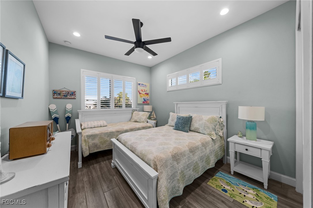 2743 Janet Street Matlacha, FL 33993 - Photo 23 of 45 a bedroom with a bed and a chandelier