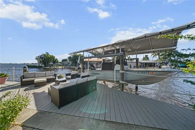 a view of a balcony with chairs and a potted plant
