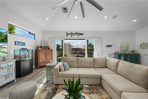 a living room with furniture ceiling fan and a rug