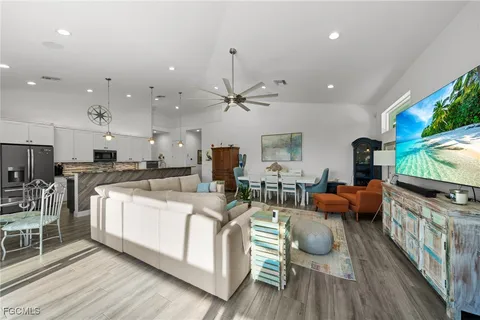 a living room with furniture a fireplace and a flat screen tv