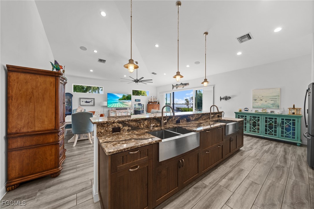 2743 Janet Street Matlacha, FL 33993 - Photo 10 of 45 a kitchen with stainless steel appliances granite countertop a stove a sink a refrigerator and a wooden floor