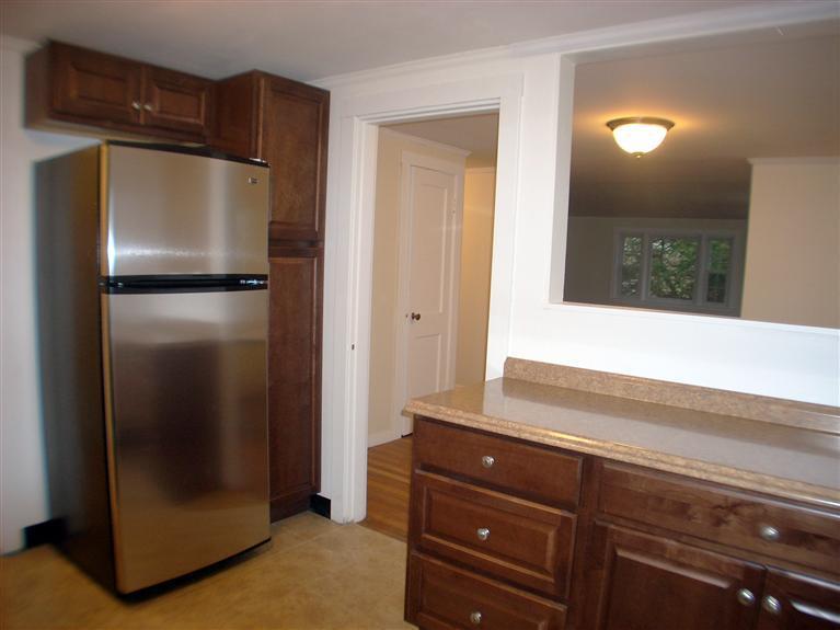6 Bacon Road Hyannis, MA 02601 - Photo 3 of 27 a kitchen with a refrigerator and cabinets