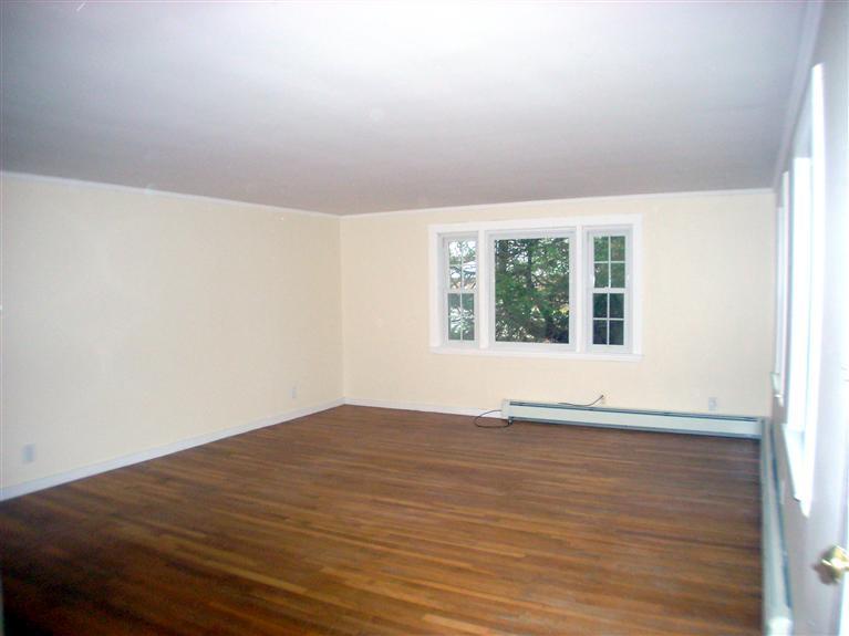 6 Bacon Road Hyannis, MA 02601 - Photo 5 of 27 a view of an empty room with wooden floor and a window