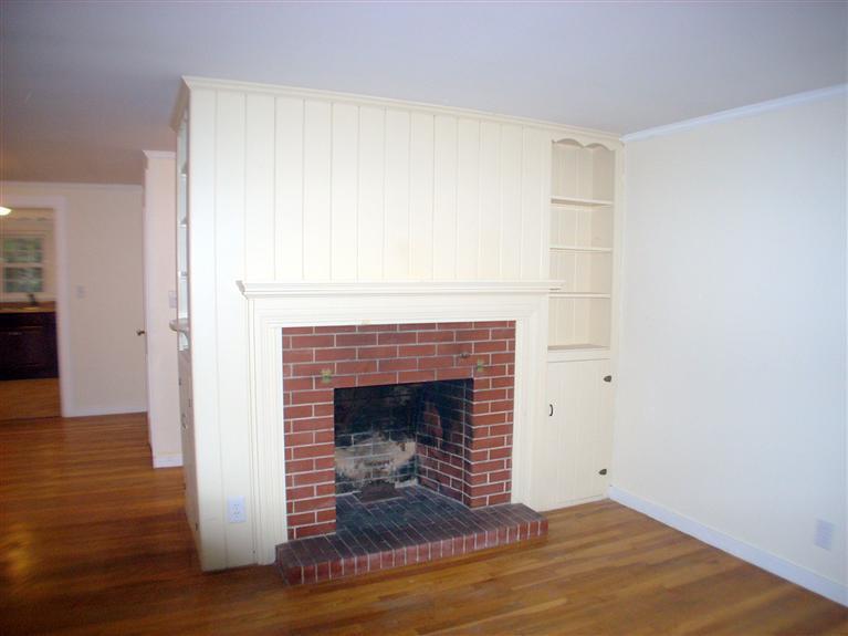 6 Bacon Road Hyannis, MA 02601 - Photo 6 of 27 a view of an empty room with wooden floor and a fireplace