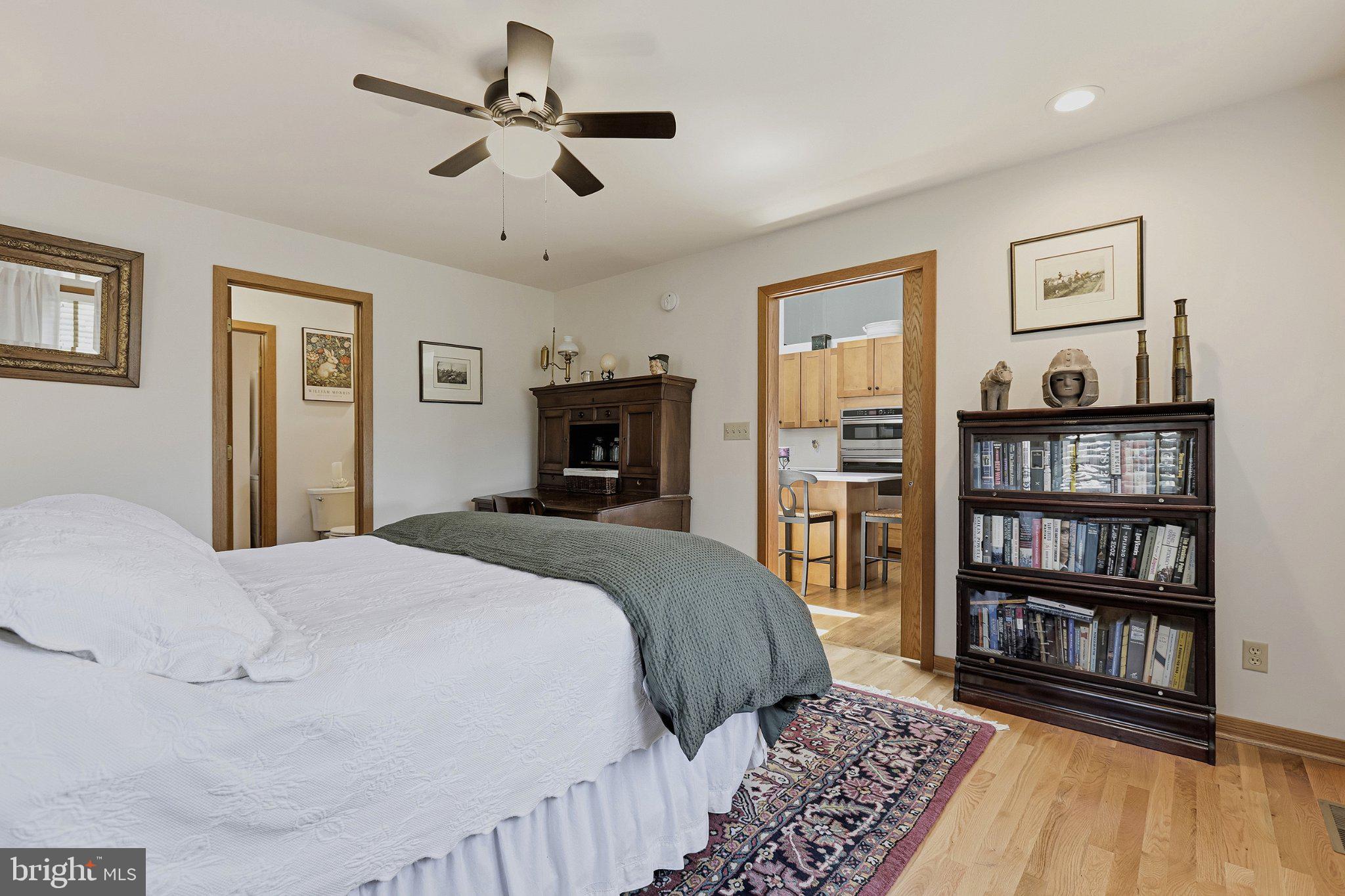 6495 Tides Road King George, VA 22485 - Photo 25 of 65 a bedroom with a large bed a flat screen tv and a book shelf