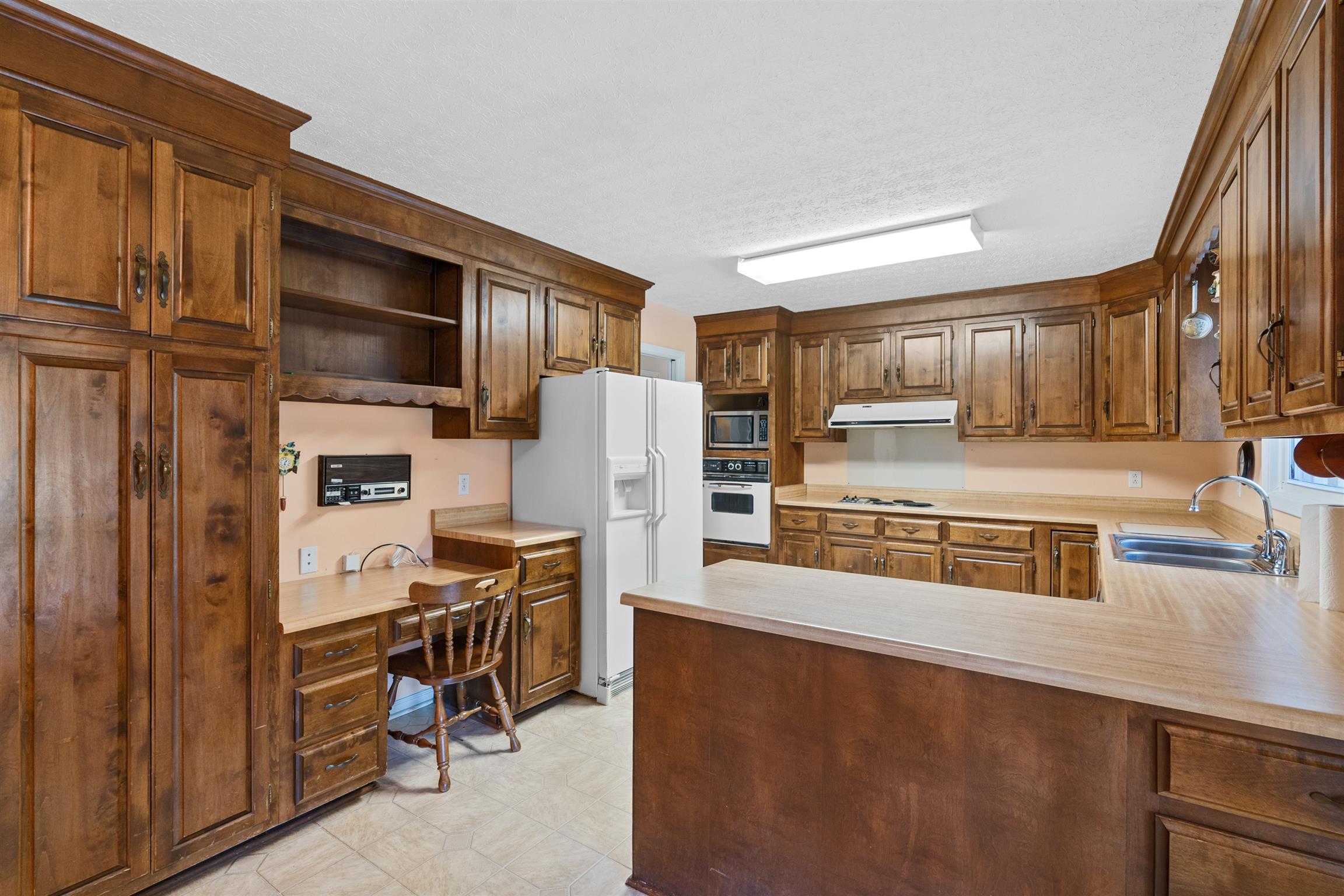 5338 New Chapel Road Springfield, TN 37172 - Photo 9 of 22 a kitchen with stainless steel appliances a refrigerator and a stove top oven