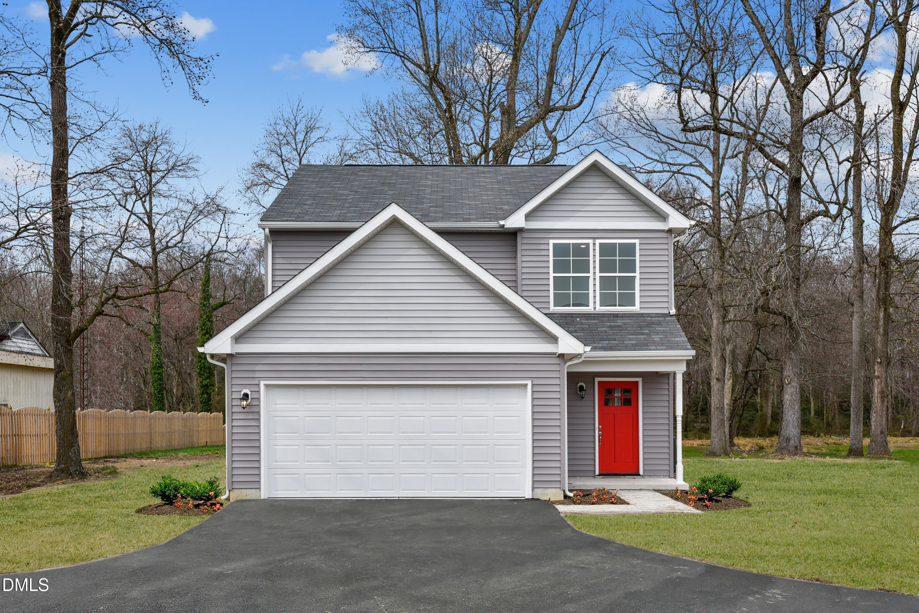 a front view of house with yard and trees