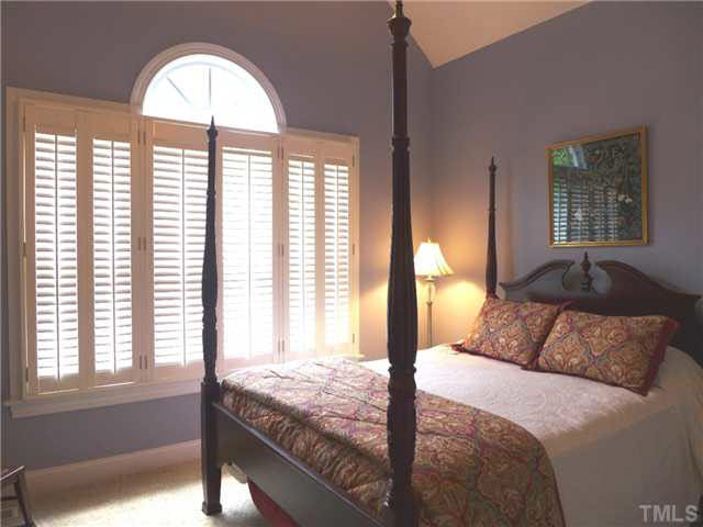 7209 Sparhawk Road Wake Forest, NC 27587 - Photo 14 of 25 There is also another 1st flr Bedroom w/neutral carpet, vaulted ceiling, arched-top triple window, plantation shutters, lg closet and an adjacent full Bath w/pedestal sink, lg tiled shower & tiled floor. Bedroom