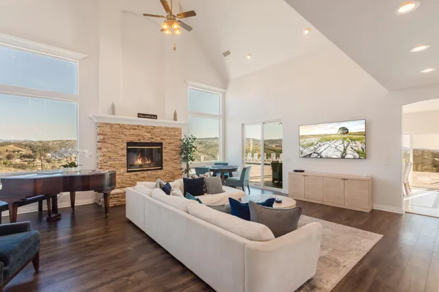 a living room with furniture a fireplace and a table
