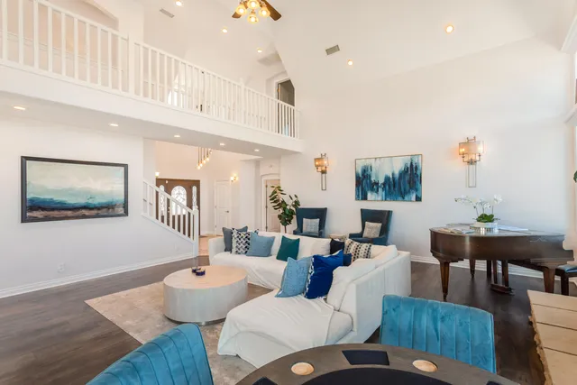 a view of a dining room with furniture large windows and wooden floor
