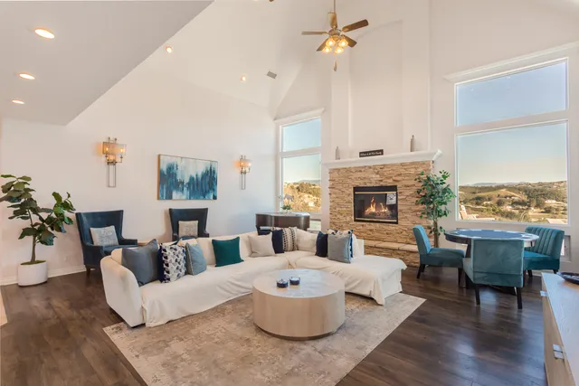 a view of a kitchen with kitchen island a stove a sink a refrigerator and a dining table