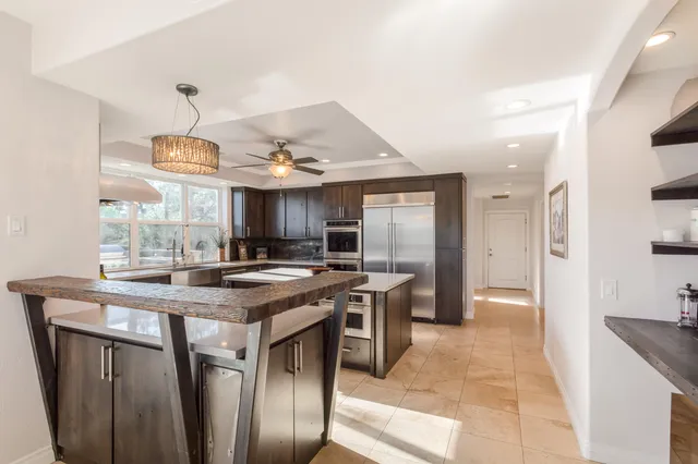 a kitchen with a stove a refrigerator and a sink