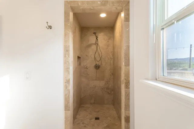 a bathroom with a double vanity sink shower and a bathtub