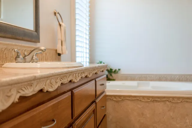 a spacious bedroom with a bed and a chandelier