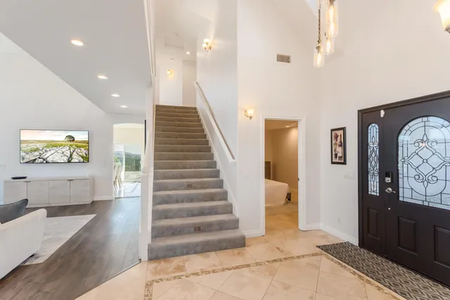 a bathroom with a granite countertop sink a mirror and a shower
