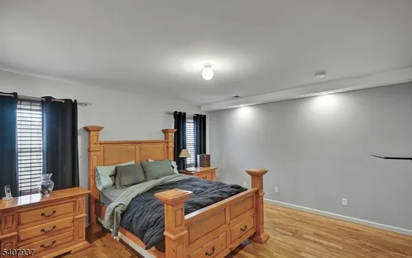 a bedroom with a bed and a mirror