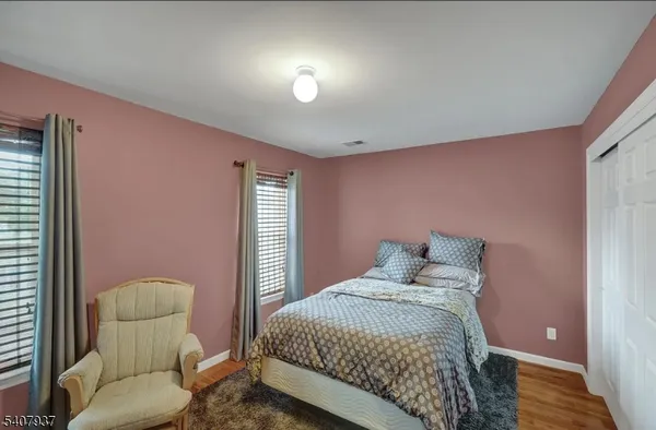 a bedroom with a bed and chair