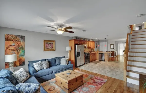 a living room with furniture and kitchen view