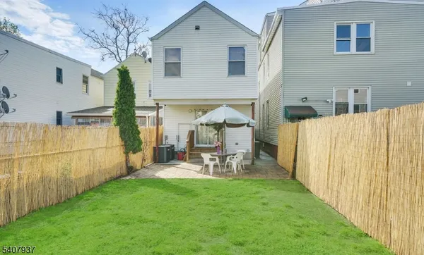 a view of backyard with a table and chairs