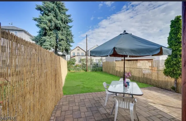 a view of a table and chairs under an umbrella
