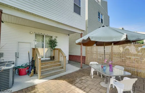 a balcony with table and chairs